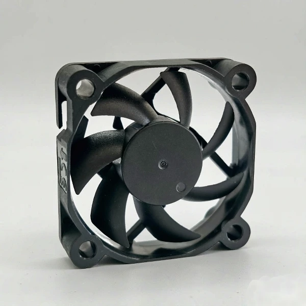 DC axial cooling fan with curved blades in a square black frame, used for straight-through enclosure ventilation